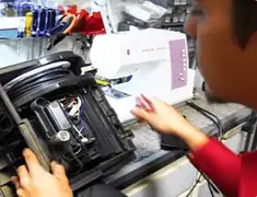 Vacuum repair technician servicing internal components on a workbench in Marietta, GA